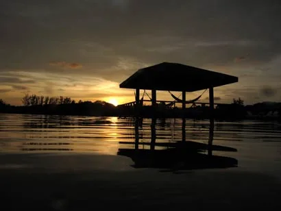 Over-water cabana silhouetted at sunset, CoCo View Resort, Roatan